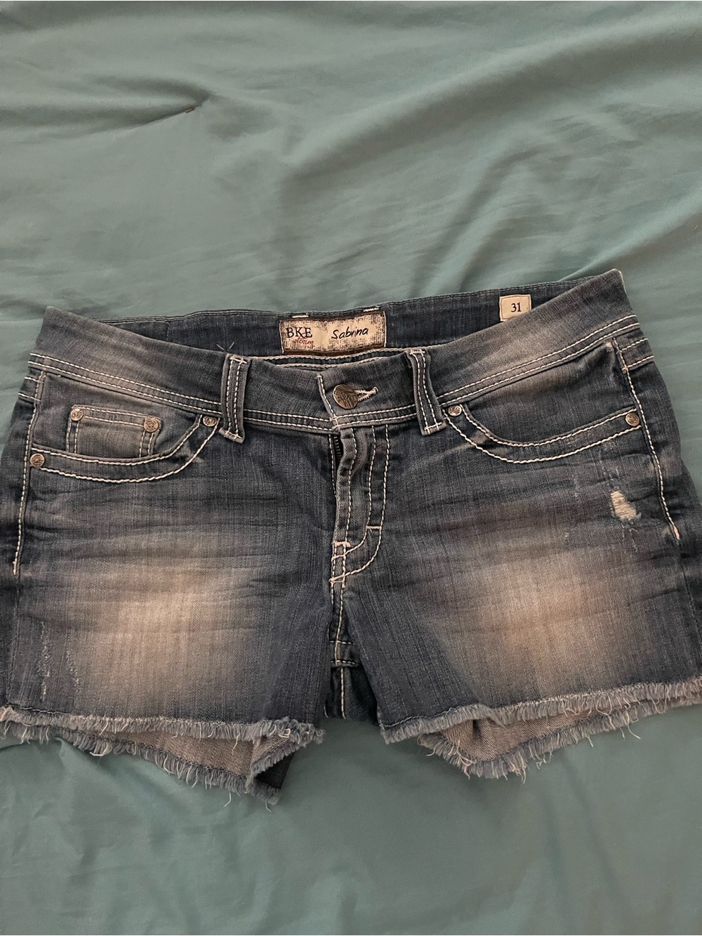 Buckle Sabrina Women’s Distressed Jean Shorts in Faded Blue